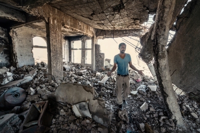 Taiz City, Taiz. A man walks through his destroyed home in the Al Gamalia neighborhood in a badly damaged part of Taiz City.