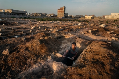 Aden cemetery, Aden, Yemen. November 2020.
A gravedigger at work in the Dar Saad area of Aden city. This cemetery is where the majority of suspected COVID-19 patients were buried after passing during the height of the 2020 pandemic. Islamic tradition requires that bodies are buried within 24 hours of death - another factor complicating tracking COVID-19 victims.