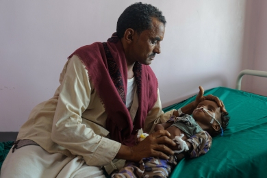 Al Sadaqah Hospital, Aden, Yemen. November 24, 2020. Four year old Abdo Sayid is comforted by his uncle Yahya in the severe-acute malnutrition ward in Al Sadaqah hospital. At the time of photography, Abdo weighed just 6.4 kilos - half the weight of a child his age. His uncle had brought him to the hospital a few days earlier from their family home near Al Hudaydah in the Houthi-controlled region of northern Yemen. Their precarious journey to Aden was negotiated thru areas of active conflict and armed checkpoints. 
After 10 days of treatment and the valiant efforts of the doctors at Al Sadaqah hospital, southern Yemen's only specialist SAM ward, Abdo lost his battle for survival and passed away on the morning of December 3rd 2020. 
The ongoing 6 year old Yemen War has destroyed infrastructure throughout the country. Basic human services such as healthcare, clean water and food supplies have been severely impacted leaving millions more children like Abdo at risk.